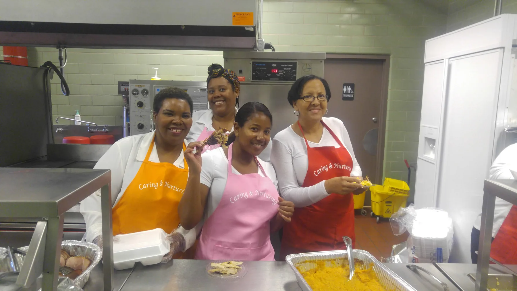 C.A.N. volunteers plating food in the kitchen before Thanksgiving dinner service