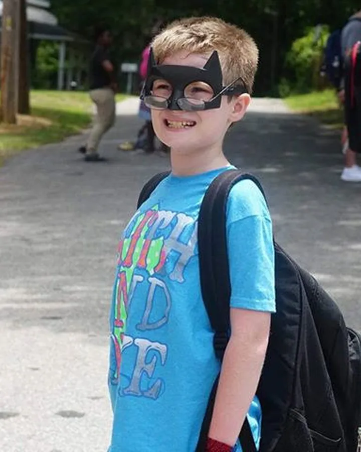 A boy wearing his new book bag at the C.A.N. back-to-school community day