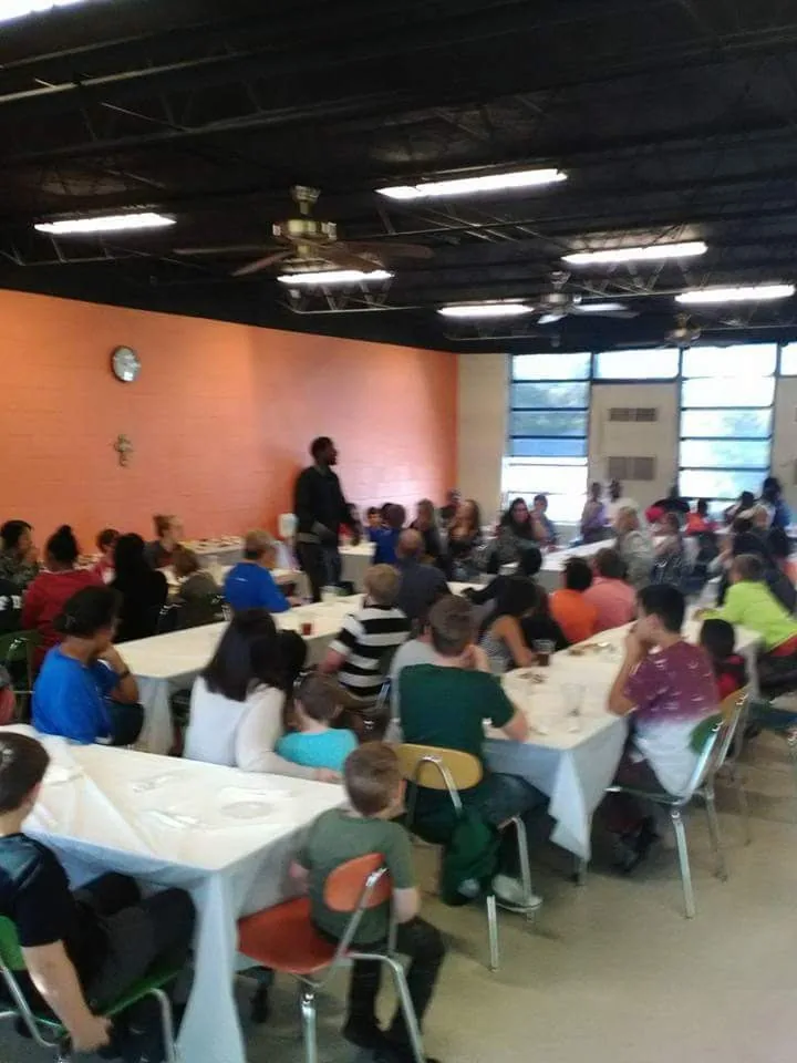 Guests seated and eating at the C.A.N. Thanksgiving dinner