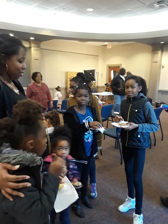 Children carrying their plates at the C.A.N. Thanksgiving dinner